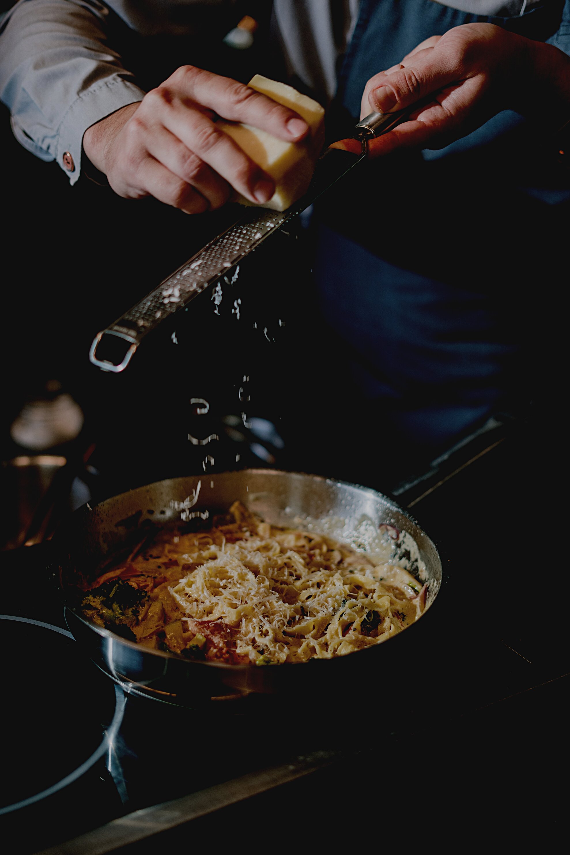 Person Holding Stainless Steel Cooking Pot With Pasta